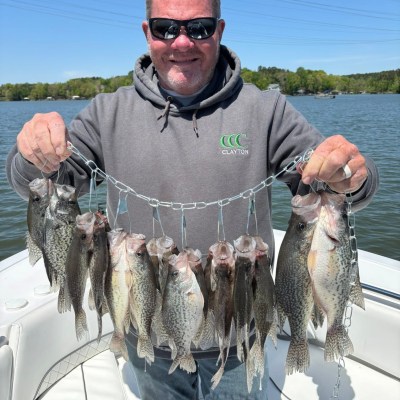 a man holding a fish in the water