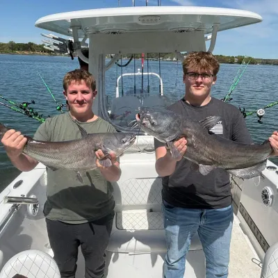 a man holding a kite in a boat on a body of water