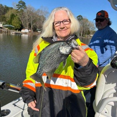 a person holding a fish in the water