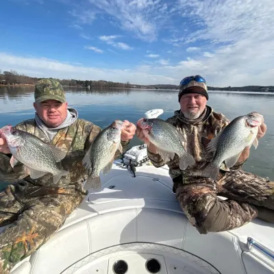a man holding a fish on a boat